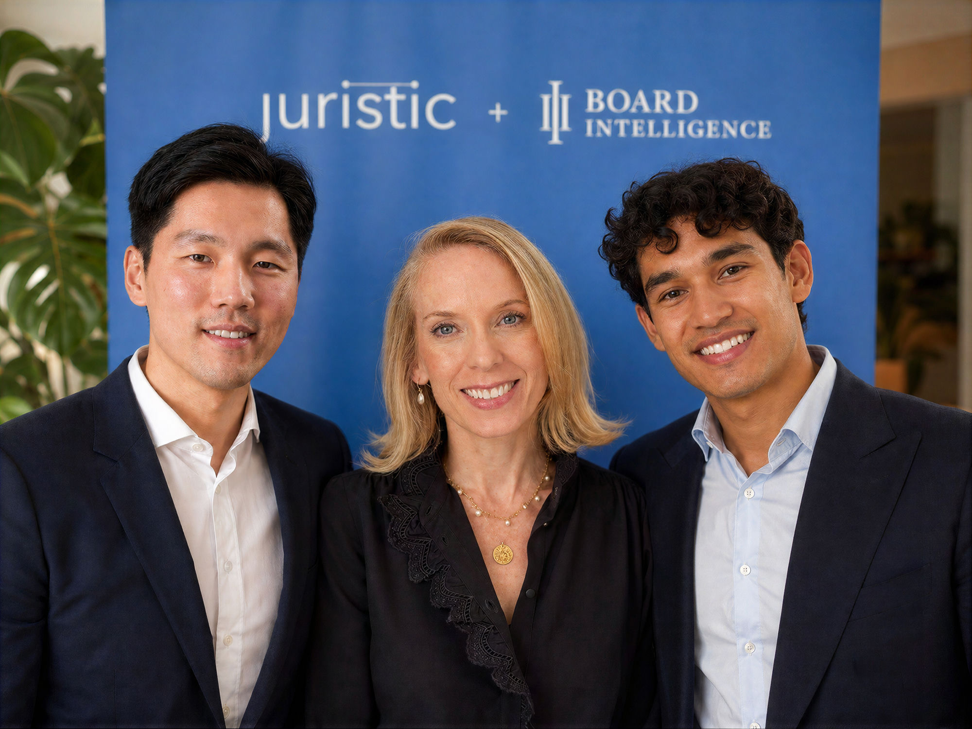 The founders of Juristic and Board Intelligence together in front of a Juristic + Board Intelligence backdrop